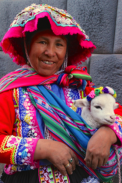 old woman and baby llama peru